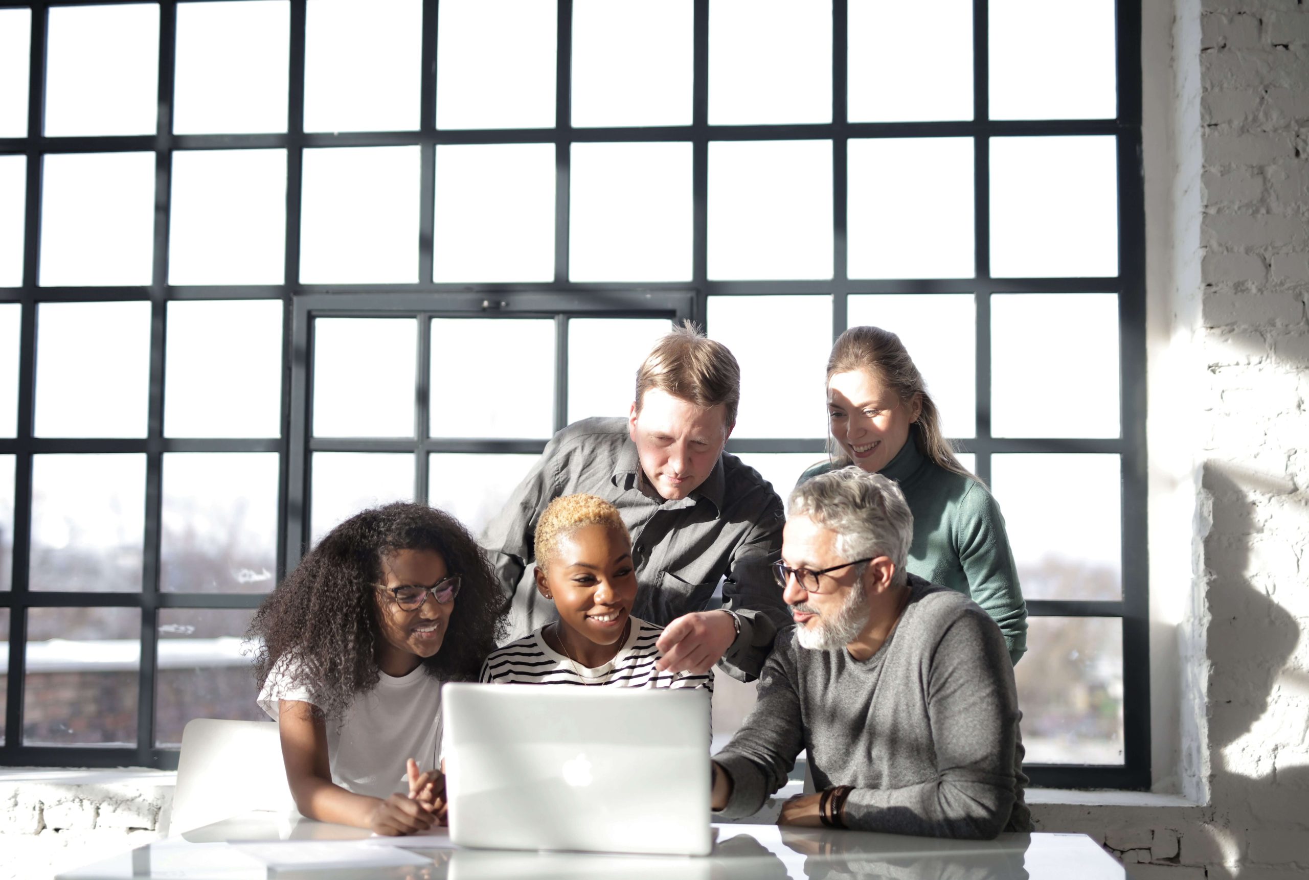 Group of people looking at a laptop